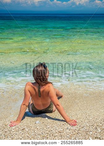 woman sunbathing on the beach summer travel holidays