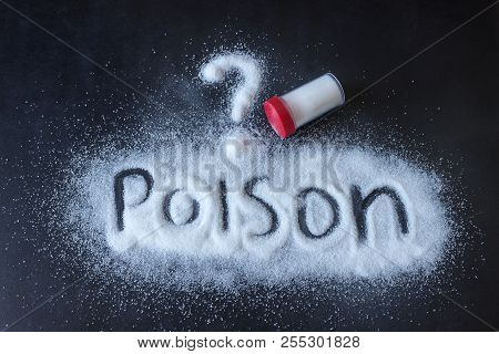 Salt Scattered On Black Surface. Written Word- Poison. Concept- Healthy Food, Diet, Harm To Health F