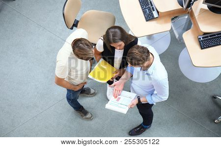 Top View Of Young Modern Colleagues In Smart Casual Wear Working Together While Spending Time In The