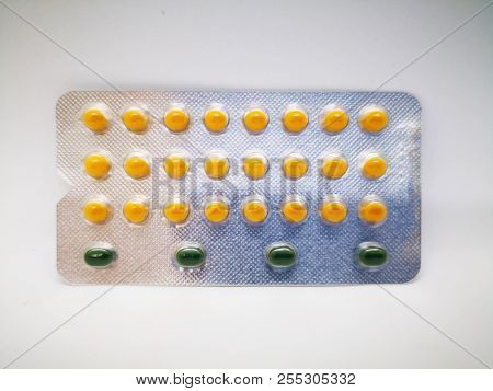 Medication And Healthcare Concept. Oral Contraceptive Drug. 24 Yellow Pills Consist Of Ethinyl Estra