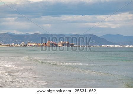 Beach Of Valencia, Spain. Panorama Of Cloudy Beach With Waves Of The Sea. Empty Spring Beach Of Medi