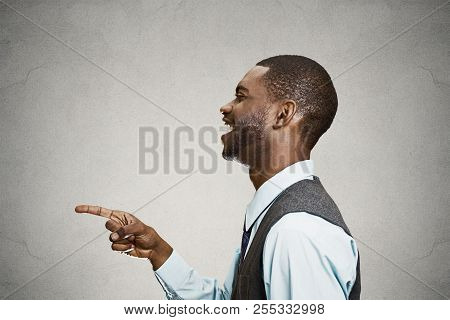 Closeup Side View Portrait Happy Young Man, Laughing, Pointing With Finger At Someone, Something, Is