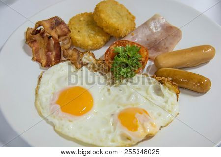 Breakfast With Sausages Ham Bacon And Potato On Plate