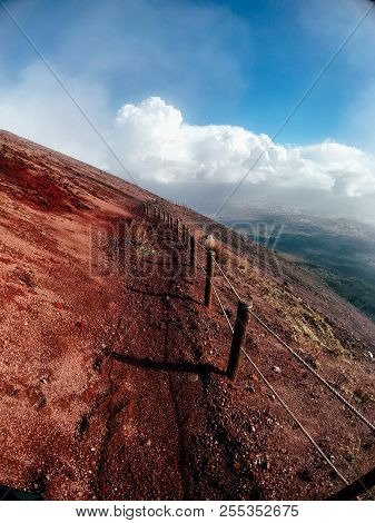 A Mountain Path Bordered By Red Cliffs