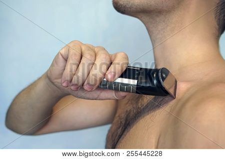 Man, Shaved, Hariy Chest. Man Shaving His Chest With Trimmer, Closeup Of Body
