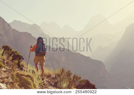 Wanderlust time. Man hiking in beautiful Fann mountains in Pamir, Tajikistan. Central Asia.