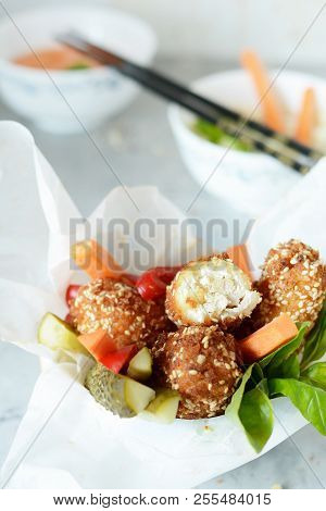 Hot Roll Of Cheese And Chicken In Breadcrumbs Of Breadcrumbs And Sesame With Fresh Vegetables And Sa