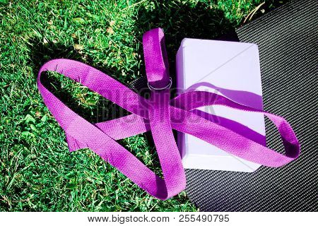 Yoga Mat On The Grass With Yoga Block. No People