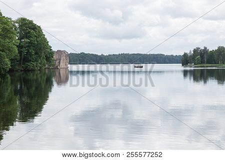 Latvia. Old River And Green Trees. Ruins And Reflection.