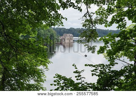 Latvia. Old River And Green Trees. Ruins And Reflection.
