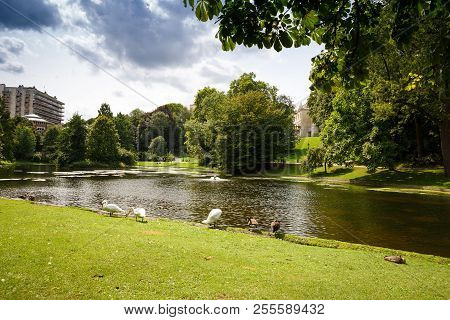 Leopold Park With Pond, Birds And People In Brussels, Belgium.
