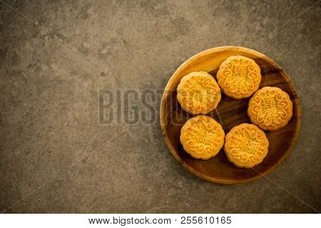 Moon cakes is traditional pastry eaten during the Mid-Autumn Festival. Flatlay on table, top down view with copy space. The Chinese character represent 