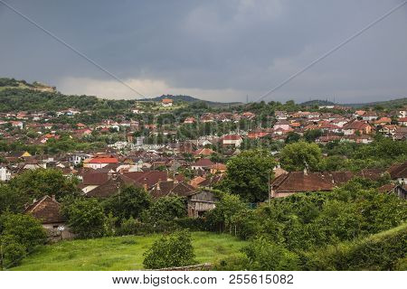 Red Roofs Of The Hunedoara City In Hunedoara County In Transylvania, Romania, Where The Corvin Castl
