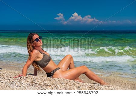 woman sunbathing on the beach summer travel holidays