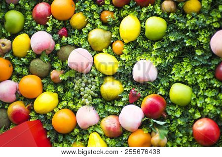 A Composition Of Fruits On A Green Background. Pattern Made From Fresh Fruits. Top View, Flat Design