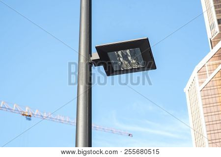 Modern Street Lights Illuminated At Day Light Against Glass And Steel Office Buildings