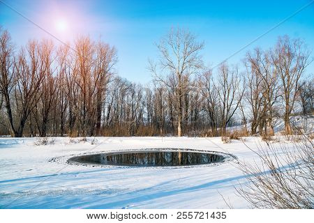 A Small Polynya On A Small Lake On A Sunny Day. Winter Landscape