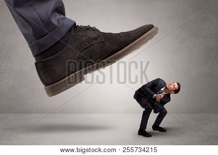 Young businessman illustrated inconsiderable by being trampled