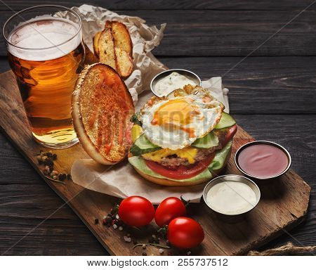 Fast Food Dish Menu. Meat Burger, Potato Chips And Wedges, Sauces And Beer On Wood