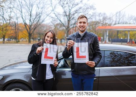 Two Persons With A Paper Sign.driving Test