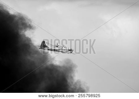 Oshkosh, Wi - 28 July 2018:  A B-29 Superfortress Bomber Flying Away From Smoke Caused By A  Bomb It