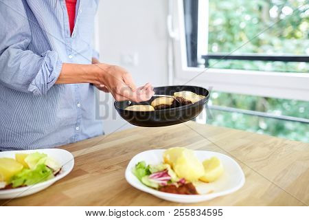 Female Hands, Black Frying Pan, Boiled Potatoes, Green Salad, Meat Cutlet With Cheese, White Ceramic