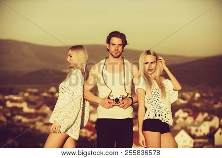 Girl And Women With Photographer Outdoor. Guy With Photo Camera On Athletic Chest. Love And Romance.
