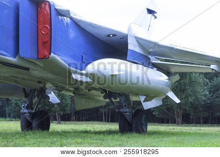 A Fighter Plane With A Bomb On Board Stands On The Ground. Close-up