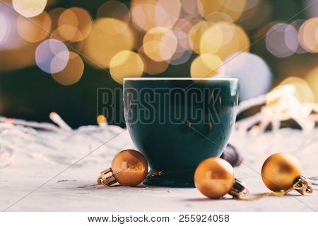 Coffee Mug With Lights Bokeh And Golden Balls With Blurred Background Christmas Concept