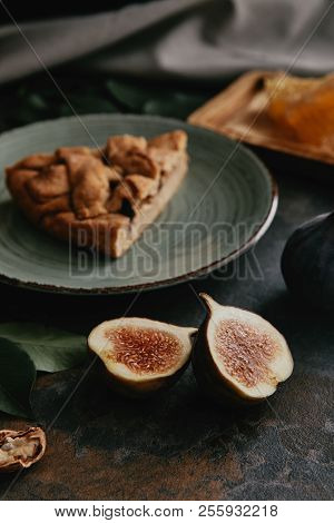 Close Up View Of Fresh Fugs And Piece Of Homemade Pie On Plate On Grungy Surface