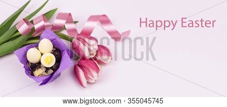 Easter Eggs. Happy Easter Card. Easter Eggs And Tulips With Ribbon On A White Wooden Background. Eas