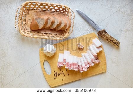 Flat Lay Composition Of Traditional Ukrainian Food, Knife, Bread Box With Dark Bread Slices, Garlic,