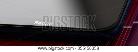 Barcelona, Spain - February 10, 2020: Xiaomi Redmi Logo At Modern Smartphone Screen Lying At Colorfu