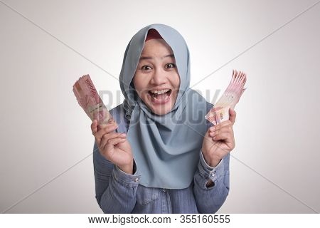 Indonesian Muslim Woman Holding Rupiah Money