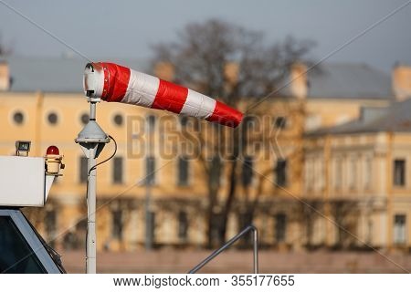 Wind Cone Against The Sky And The City