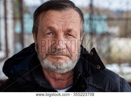 Bearded elderly country man outdoors in winter, real people