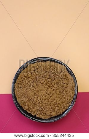Guarana Powder In A Black Cup On A Pink Beige Minimalist Style.super Food. Useful Product. Healthy E