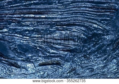 Blue Shiny Metal Texture That Looks Like Wood Bark Structure Background. Lines And Hollows. Abstract