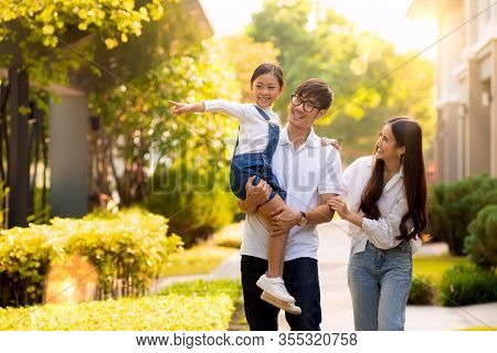 Asian Family Walking Together In The Village Gardent, This Image Can Use For Father, Mother , Daught