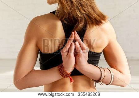 Cropped View Of Girl In Reverse Prayer Pose