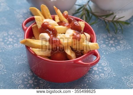Canadian poutine, fried potato chips with cheese and gravy or sauce