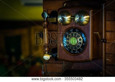 Old Vintage Wall Mount Telephone On Brick Wall, With Wooden And Brass Handle And Crank, Brass Bells 