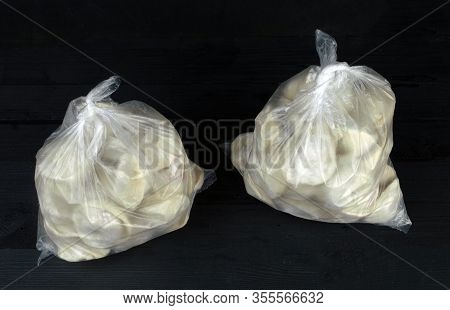 Homemade Dumplings In Packages Stand On The Table
