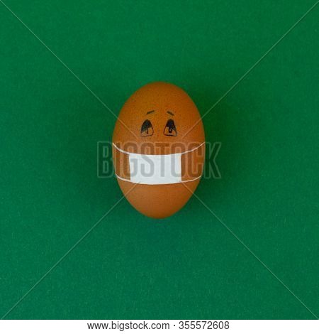 Easter Egg In Medical Mask Virus Protection Against Coronavirus On Green Background.