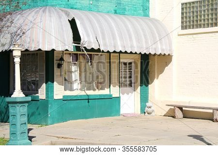 Abandoned Green Store Building Awnings Glass Brick Window Shadows