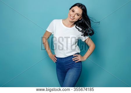 Beautiful Woman On A Blue Background In The Studio.