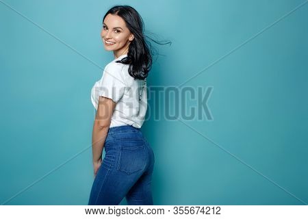 Beautiful Woman On A Blue Background In The Studio.
