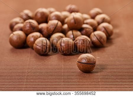 Fresh Macadam Nut Close-up On A Brown Background