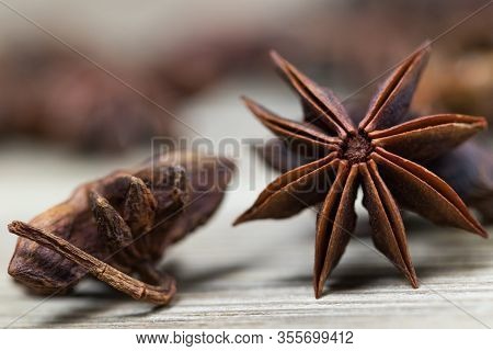Star Anise With And Without Seeds, Closed, On A Light Wooden Surface. Spice For The Recipe. Beautifu