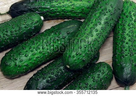 Cucumbers On A Wooden Table. Healthy, Vegetarian Food. Natural Food.vegetables On A Table. Flat Lay.
